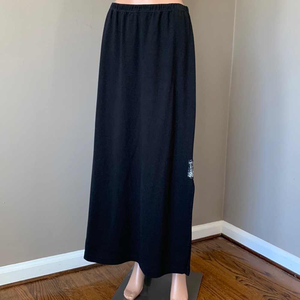 Surya Black long skirt with slits and small decorations.